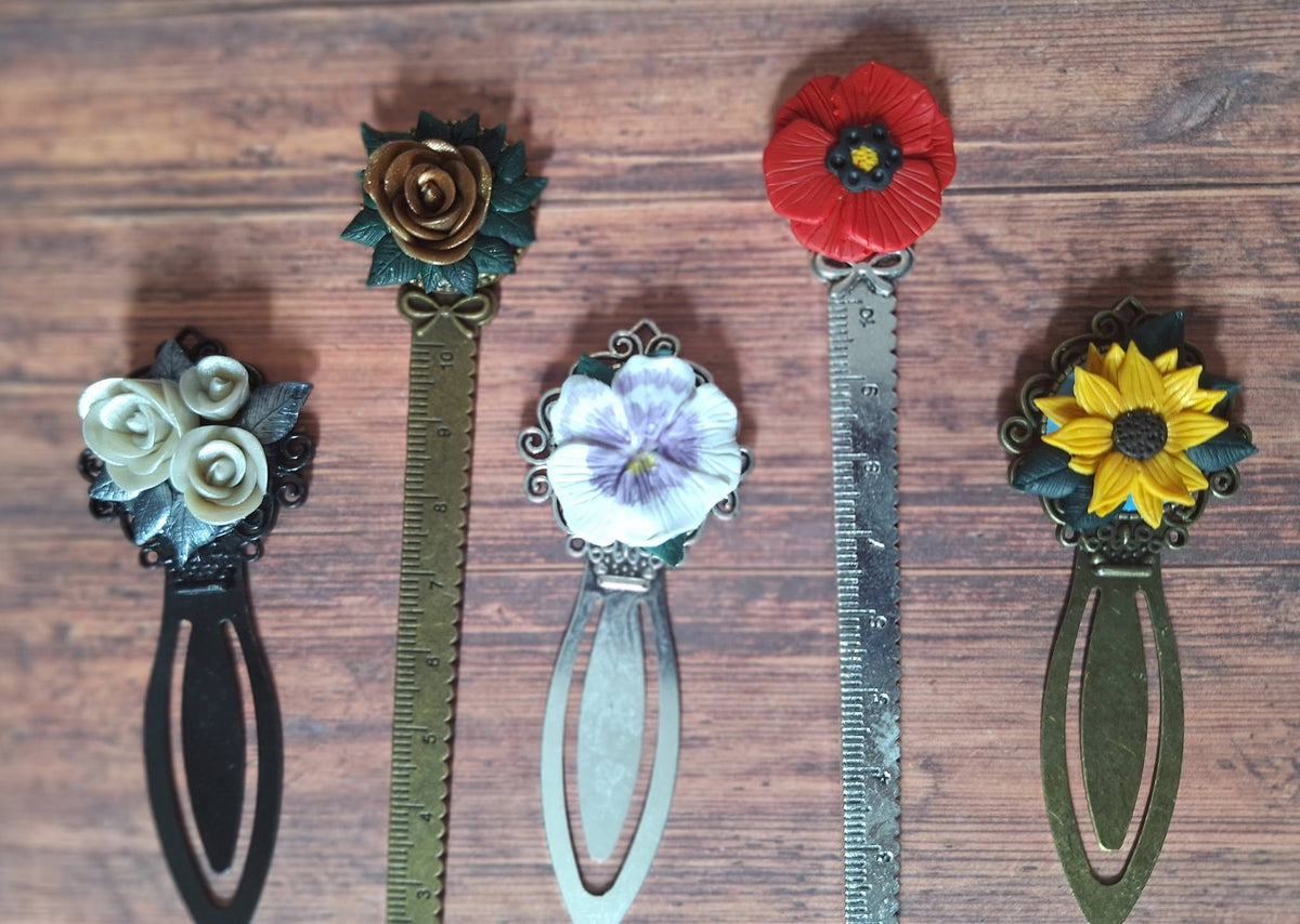 Set of five metal bookmarks with floral resin tops and ruler markings