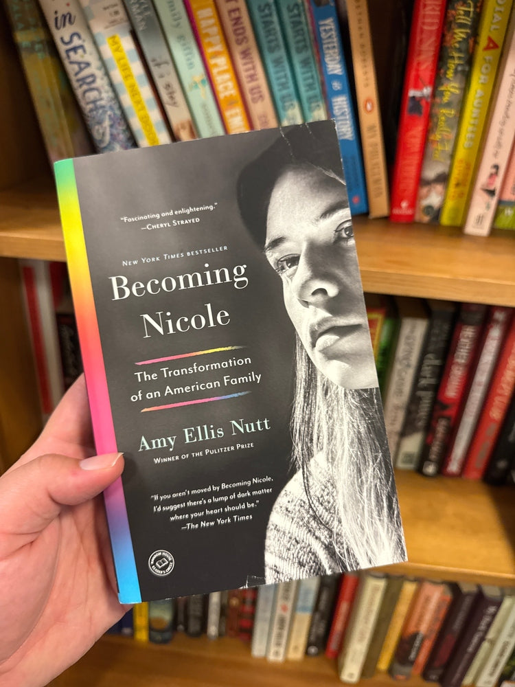 Becoming Nicole paperback book by Amy Ellis Nutt with rainbow spine and black cover