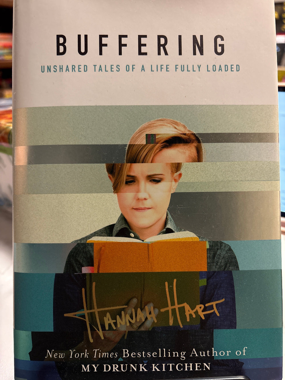 Book titled 'Buffering' with a photo of a woman on the cover, featuring the author's name.