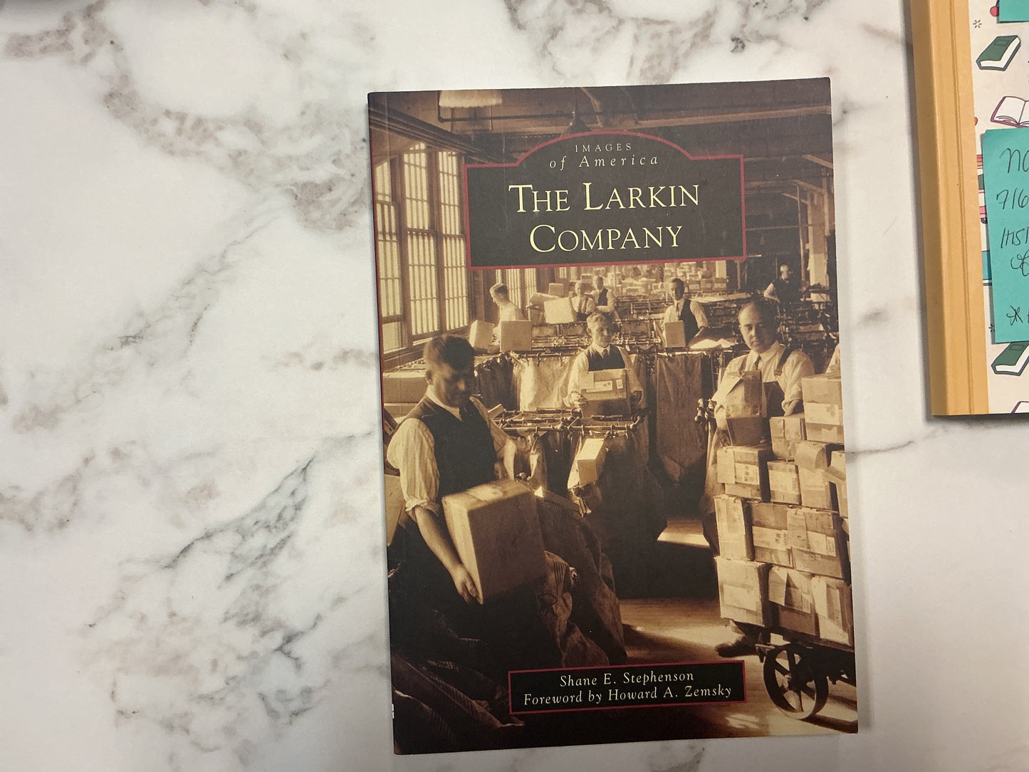 Book titled 'The Larkin Company' on a marble surface