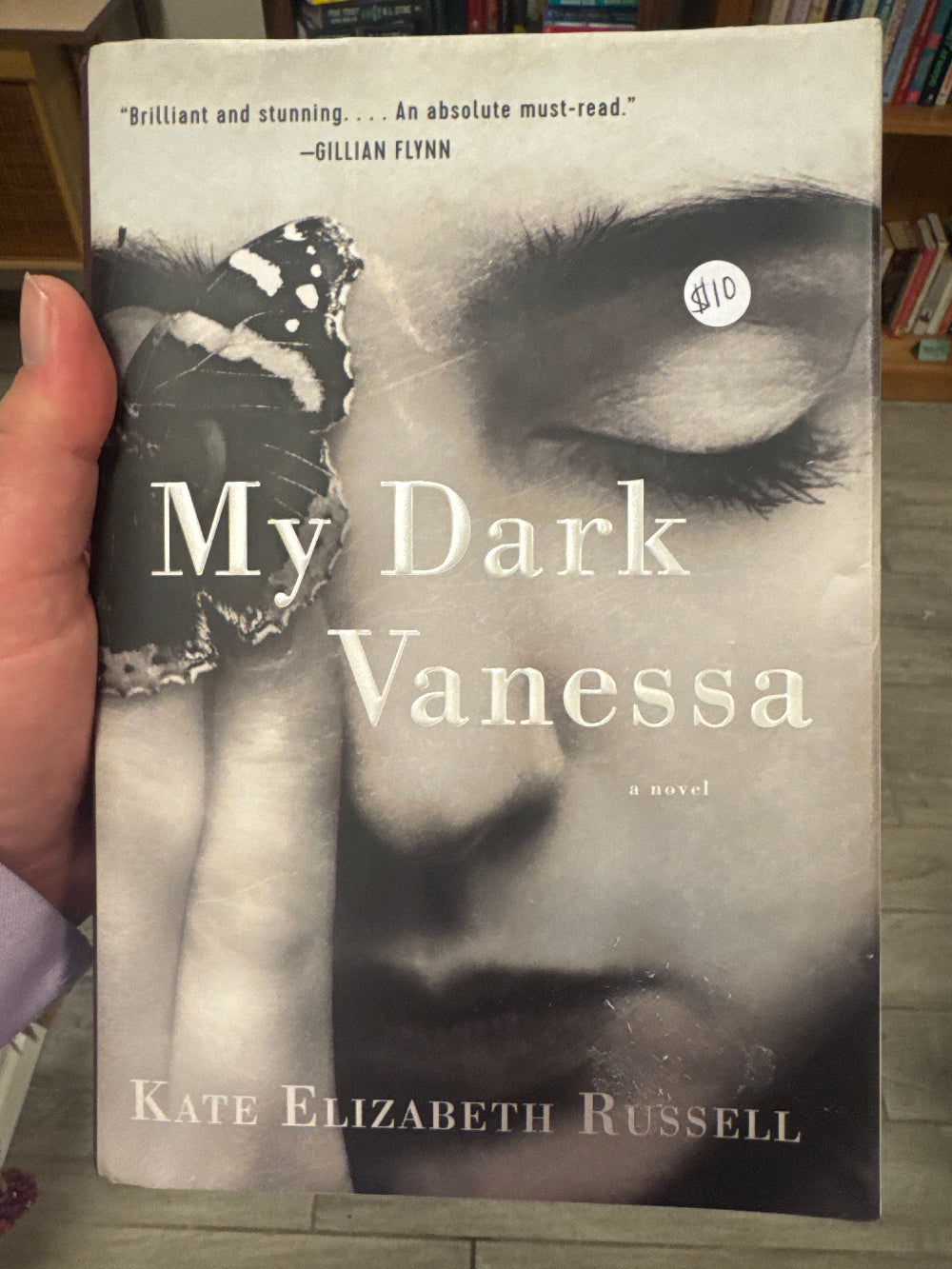 Book titled 'My Dark Vanessa' by Kate Elizabeth Russell held by a hand.