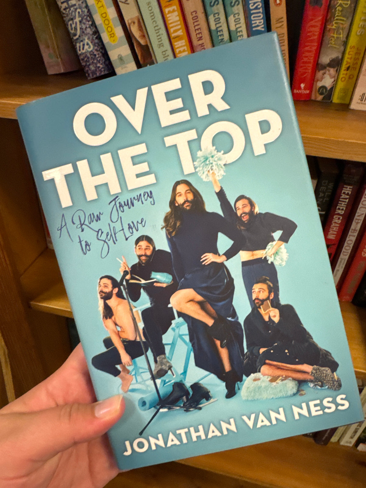 Over The Top hardcover book by Jonathan Van Ness with white title and black outfit poses