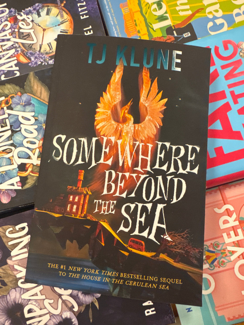 Book titled 'Somewhere Beyond the Sea' by TJ Klune on a colorful background