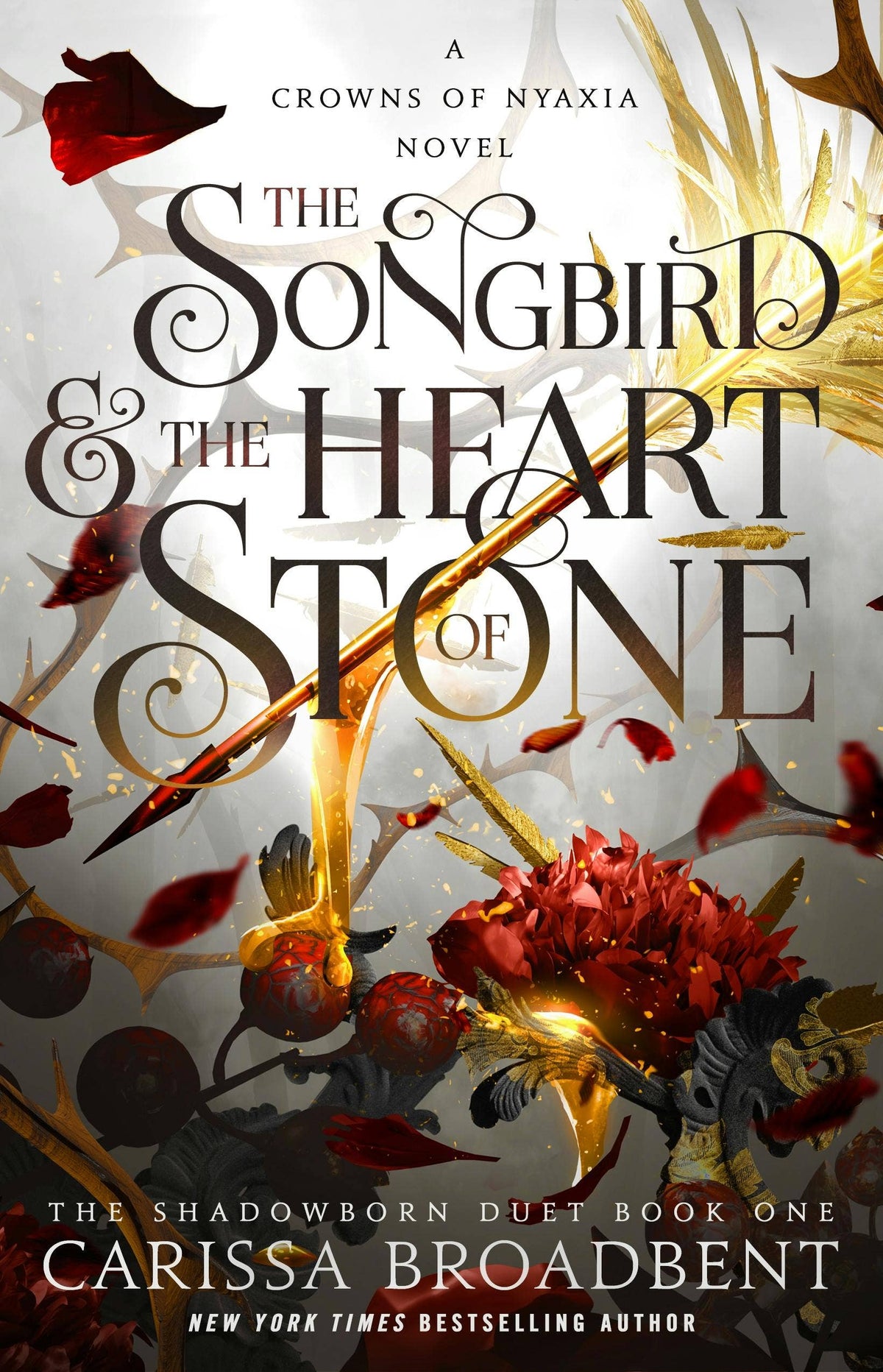 The Songbird & the Heart of Stone trade paperback by Carissa Broadbent, featuring ornate black serif title and golden arrow on grey cover