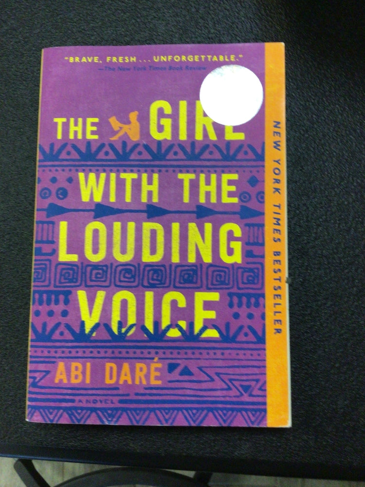 The Girl with the Louding Voice paperback by Abi Daré, purple cover with yellow title and blue geometric patterns