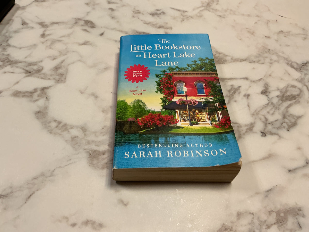 The Little Bookstore on a Heart Lake Lane paperback by Sarah Robinson with bonus story sticker