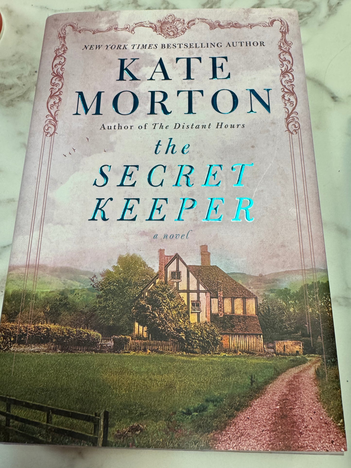 The Secret Keeper hardcover novel by Kate Morton with Tudor house cover art