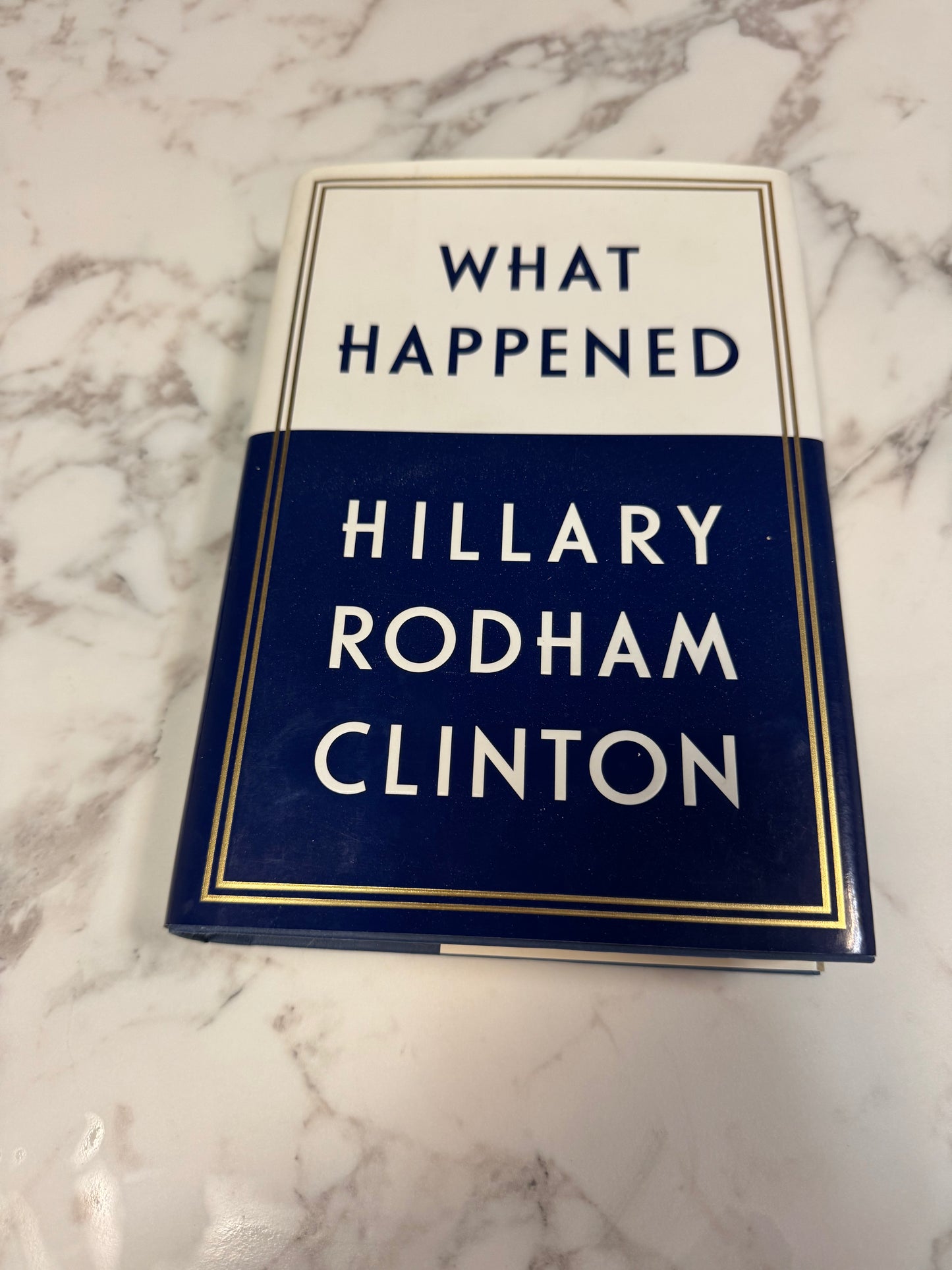 Signed hardcover copy of What Happened by Hillary Rodham Clinton with navy and white cover