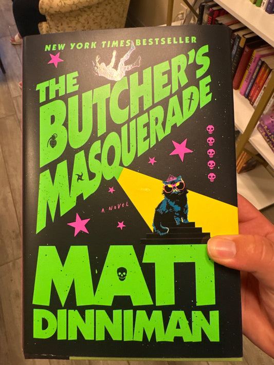 The Butcher's Masquerade hardcover book by Matt Dinniman with neon green title and fantasy cover art