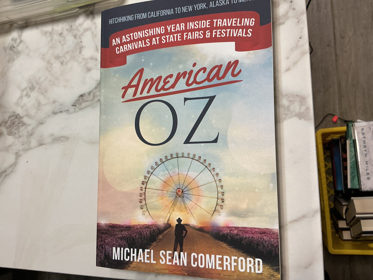 American Oz paperback book by Michael Sean Comerford with lavender and Ferris wheel cover art
