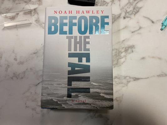 Before the Fall hardcover novel by Noah Hawley on marble surface