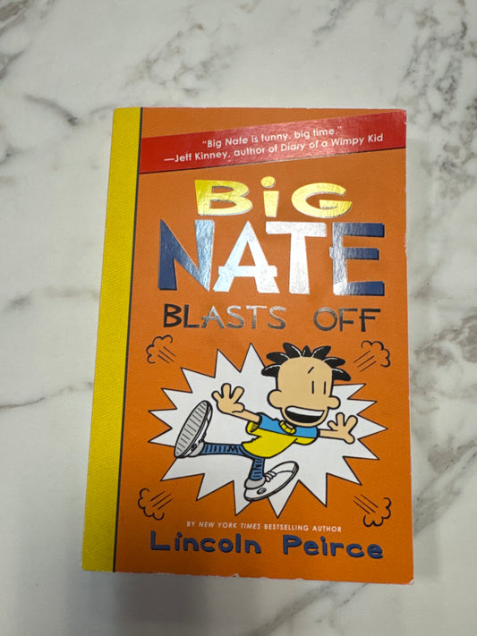 Big Nate Blasts Off paperback book by Lincoln Peirce with orange cover and cartoon illustration