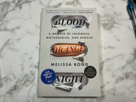 Blood Orange Night paperback by Melissa Bond with foil pill design and bonus chapter sticker