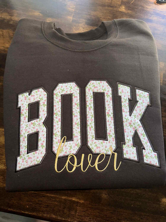 Dark brown Book Lover sweater with pink floral BOOK print and gold cursive embroidery