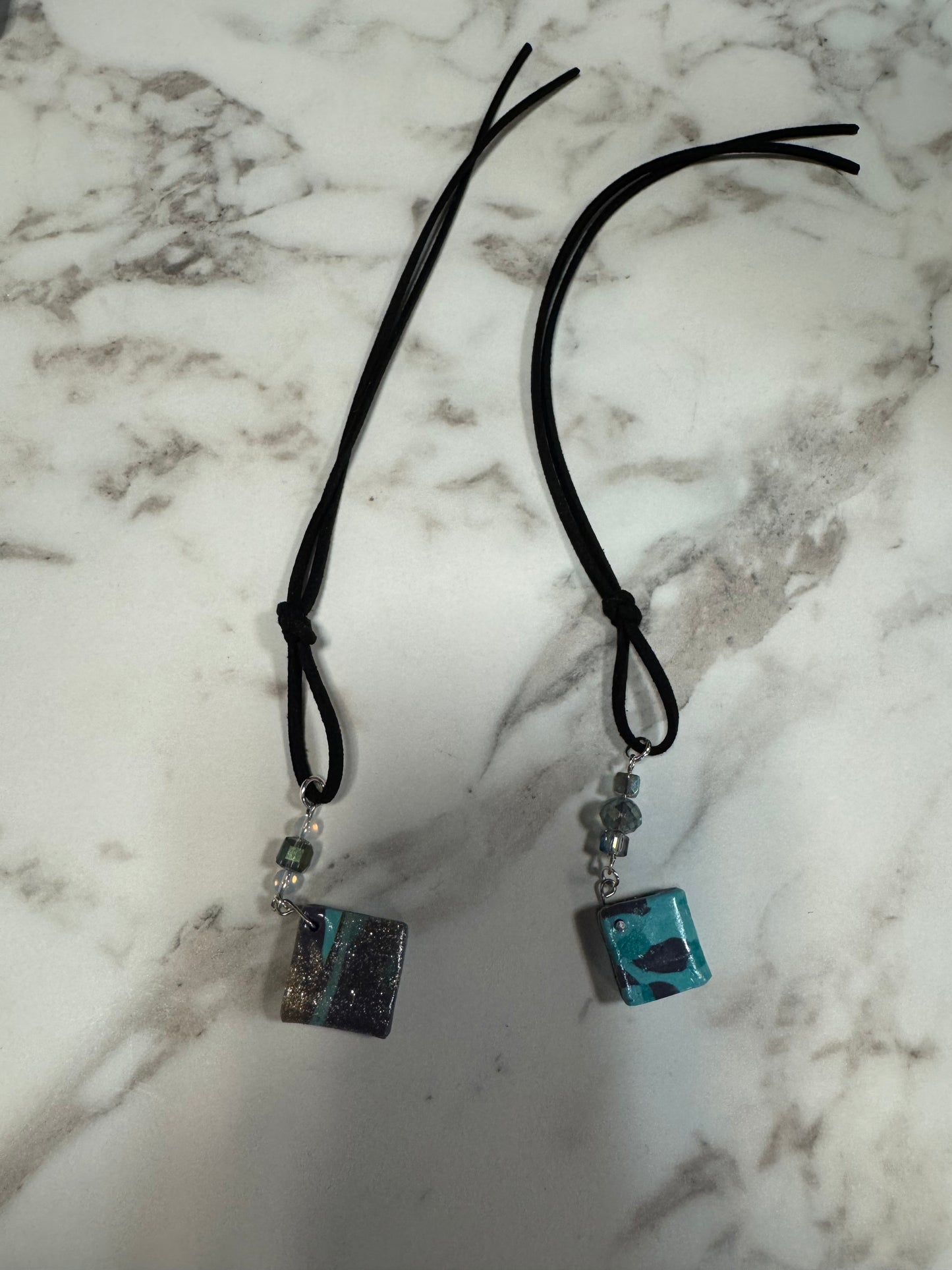 Teal and turquoise resin bookmarks with black cord strings and beads