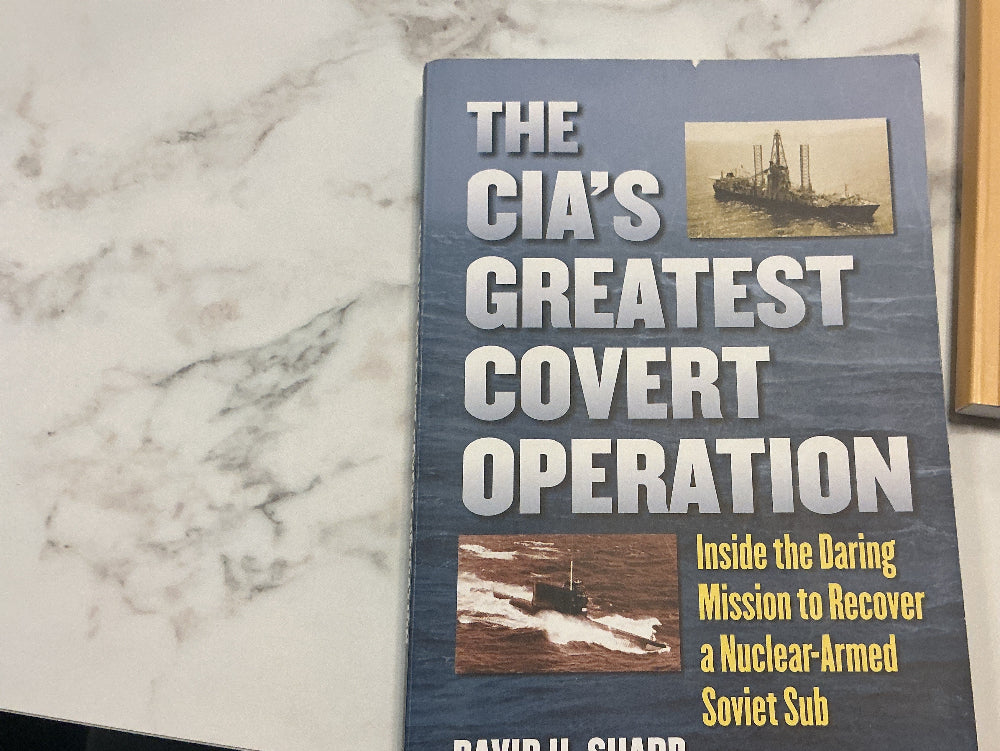 Book titled 'The CIA's Greatest Covert Operation' by David H. Sharp on a marble surface.