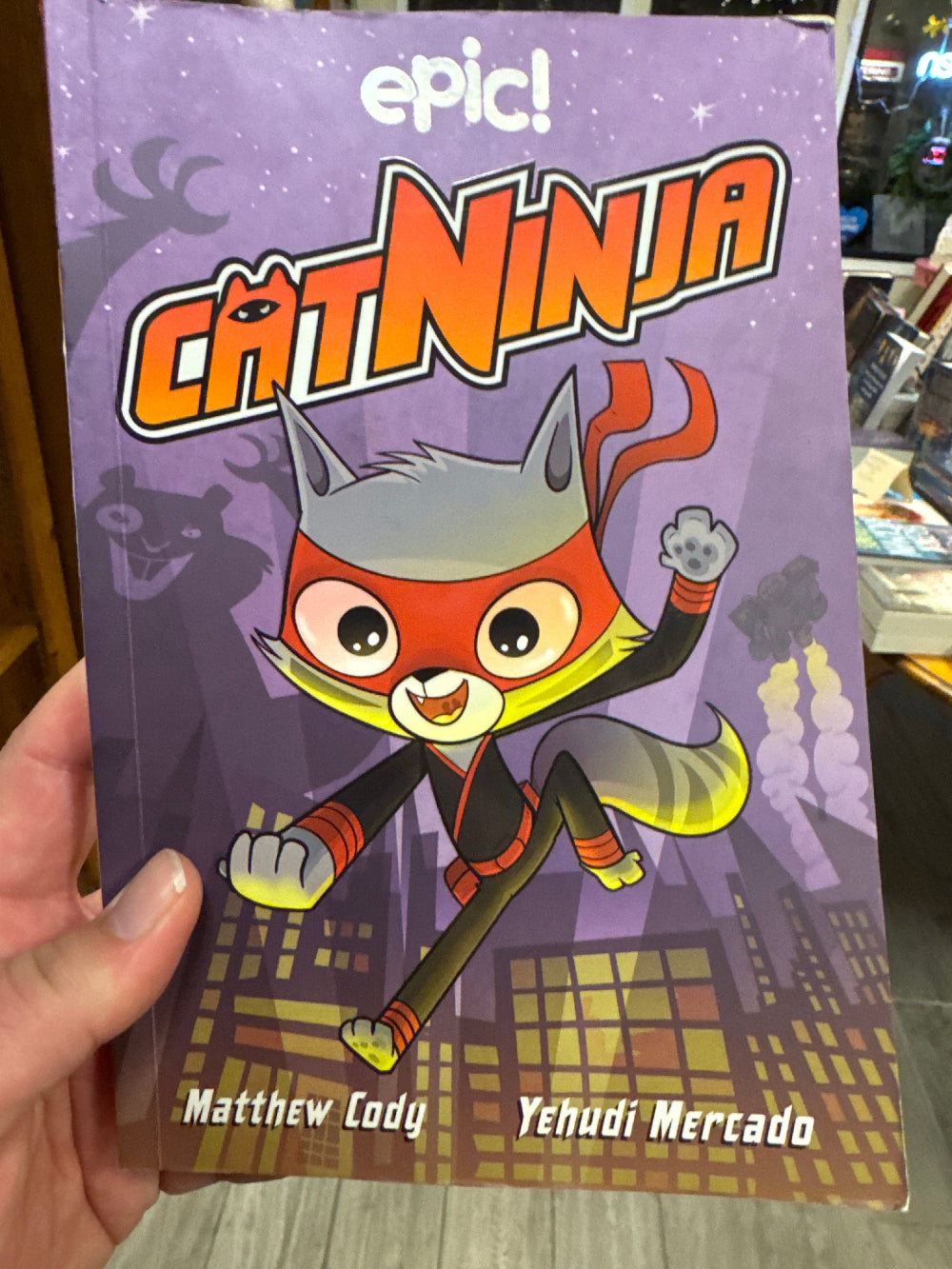 Children's book titled 'epic! Cat Nina' with a cartoon cat character on a purple cover.
