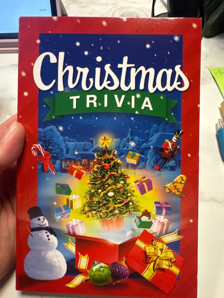 Christmas trivia book with festive design featuring a tree, presents, and snowman.