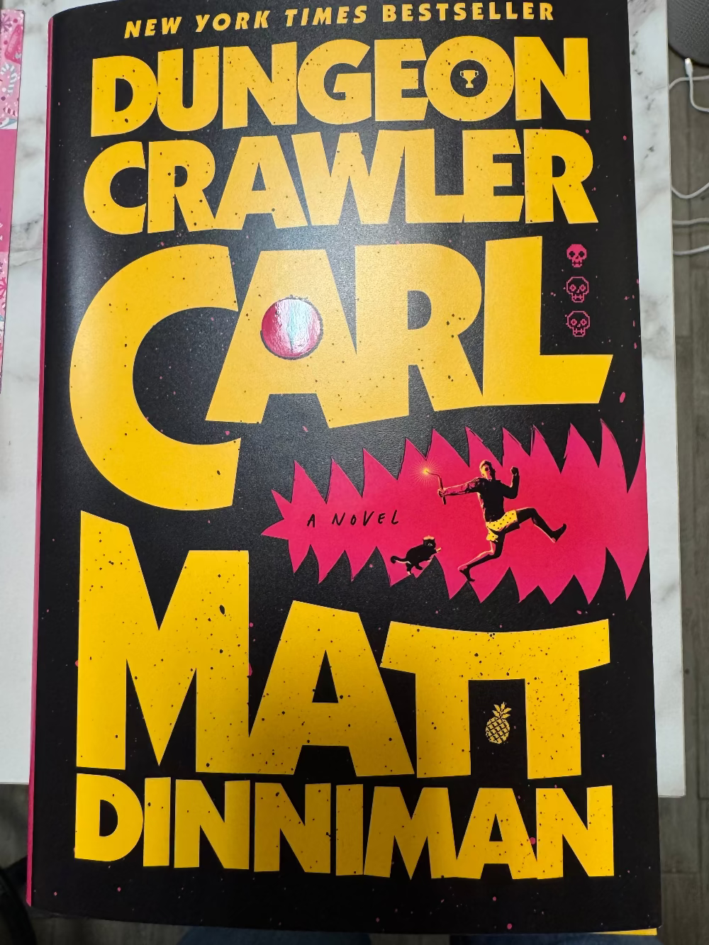 Book cover of 'Dungeon Crawler' by Carl Matt Dinniman with yellow text on a black background.
