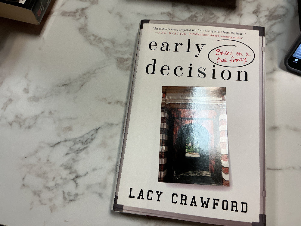 Book titled 'Early Decision' by Lacy Crawford on a marble surface