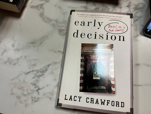 Book titled 'Early Decision' by Lacy Crawford on a marble surface