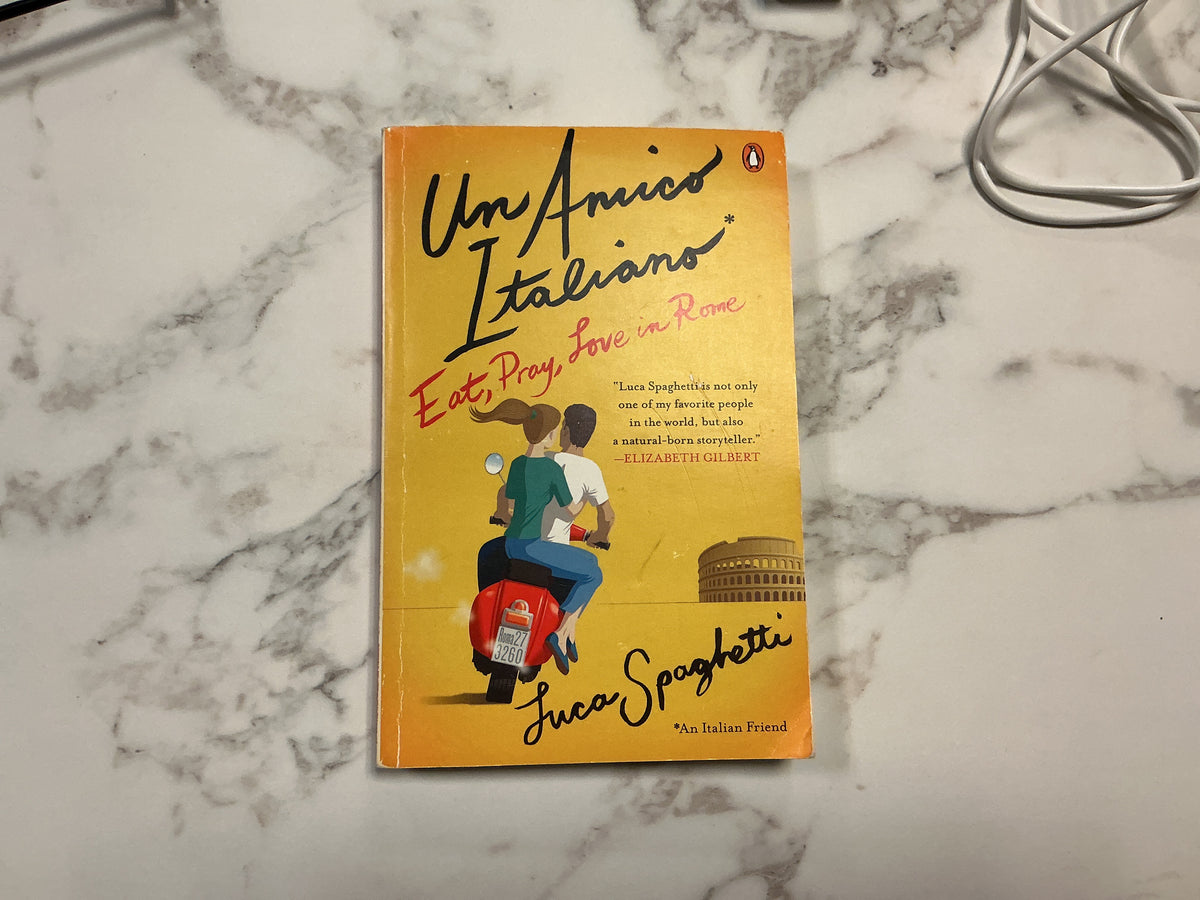 Yellow paperback book Eat Pray Love in Rome by Luca Spaghetti with scooter and Colosseum cover art