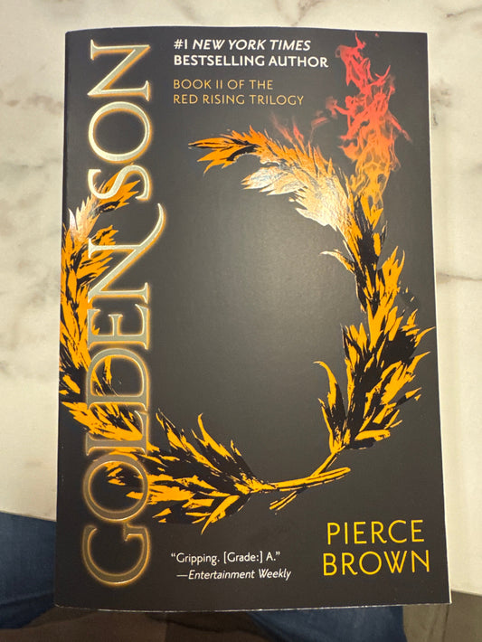 Book titled 'Copper Son' by Pierce Brown with a phoenix design on a dark background.
