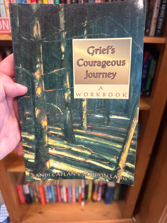 Grief's Courageous Journey softcover workbook by Sandi Caplan with dark green forest cover art
