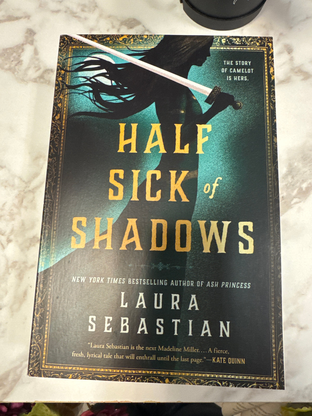 Half Sick of Shadows hardcover book by Laura Sebastian with dark teal and gold cover art