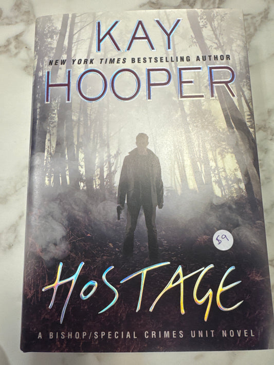 Hardcover book Hostage by Kay Hooper with foggy forest cover and silhouetted man