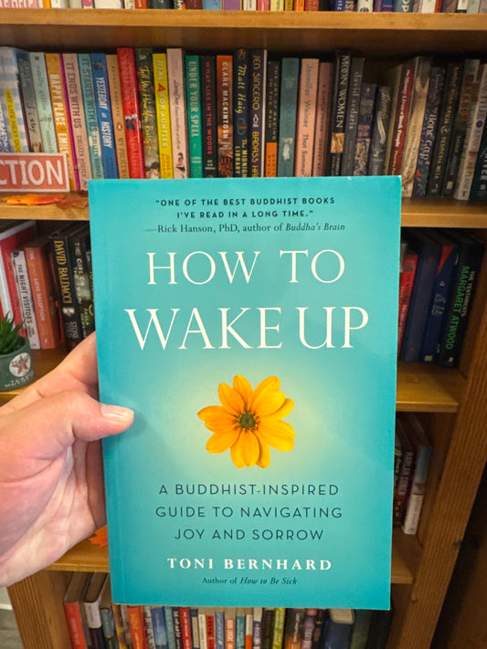 How to Wake Up hardcover book by Toni Bernhard with teal cover and yellow flower