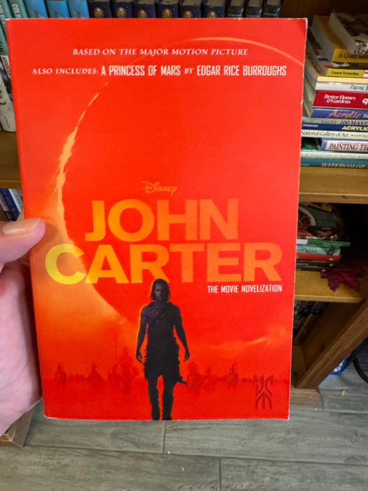 Red hardcover John Carter movie novelization book with Disney logo and orange gradient cover