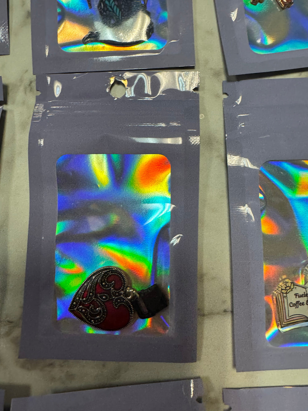 Holographic packaging with Dark Red Kindle Charm in it