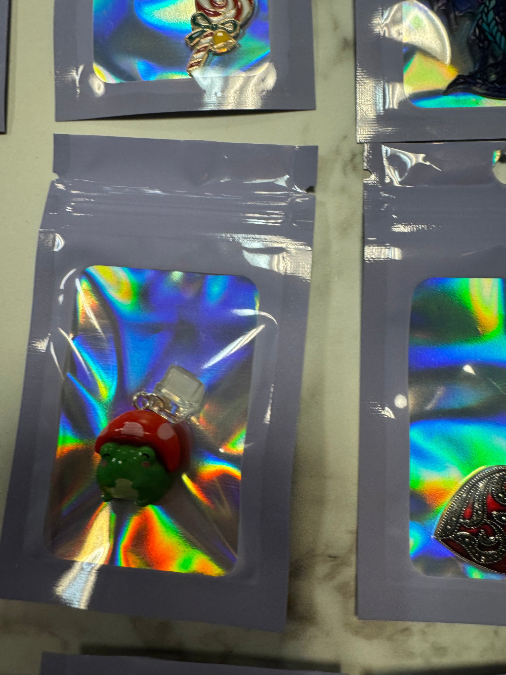 Holographic Packaging with Frog with Mushroom Hat Kindle Charm in it