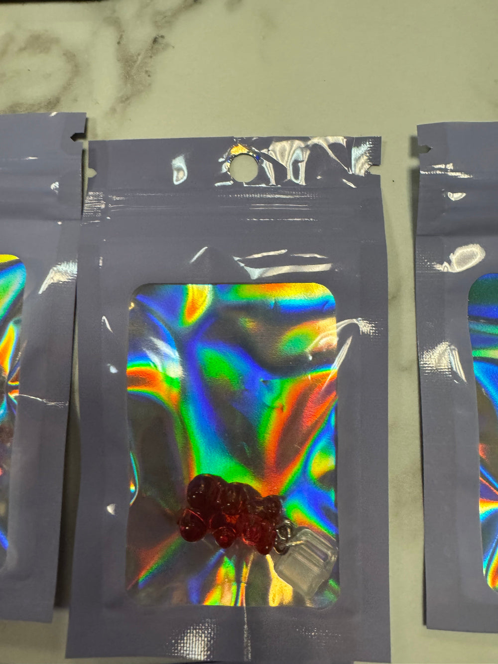 Holographic Packaging with Red Gummy Bear Kindle Charm inside
