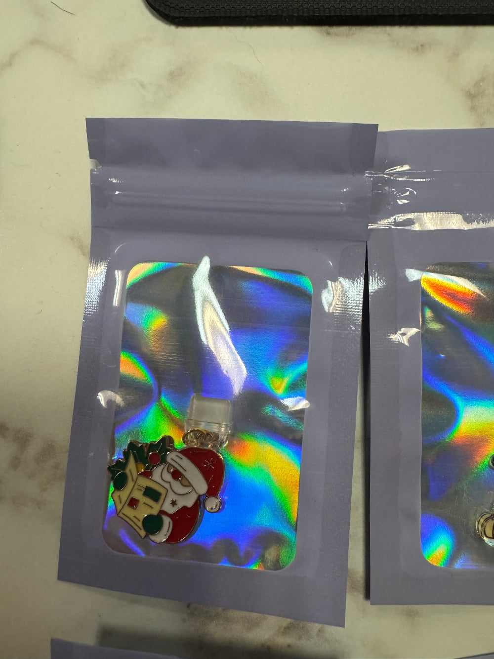 Holographic Packaging with Santa Reading Paper Kindle Charm in it