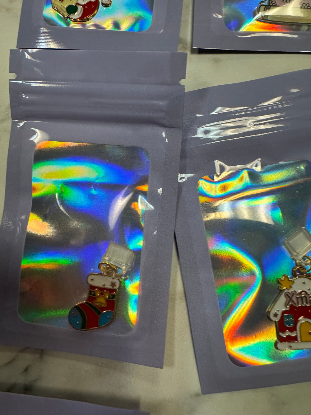 Holographic Packaging with a Christmas Stocking Kindle Charm in it