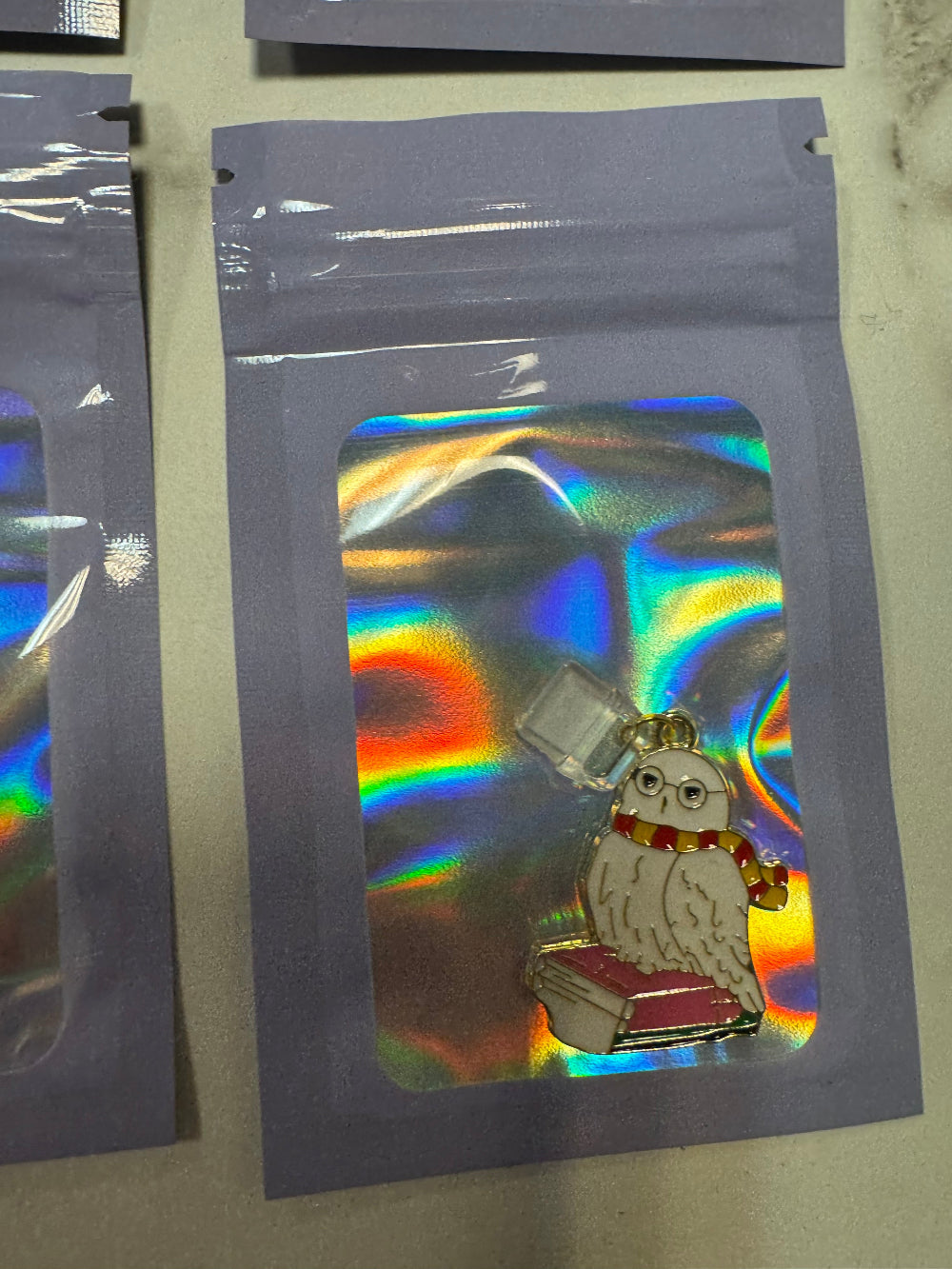 Holographic packaging with Hedwig Harry Potter's Owl as a kindle charm inside