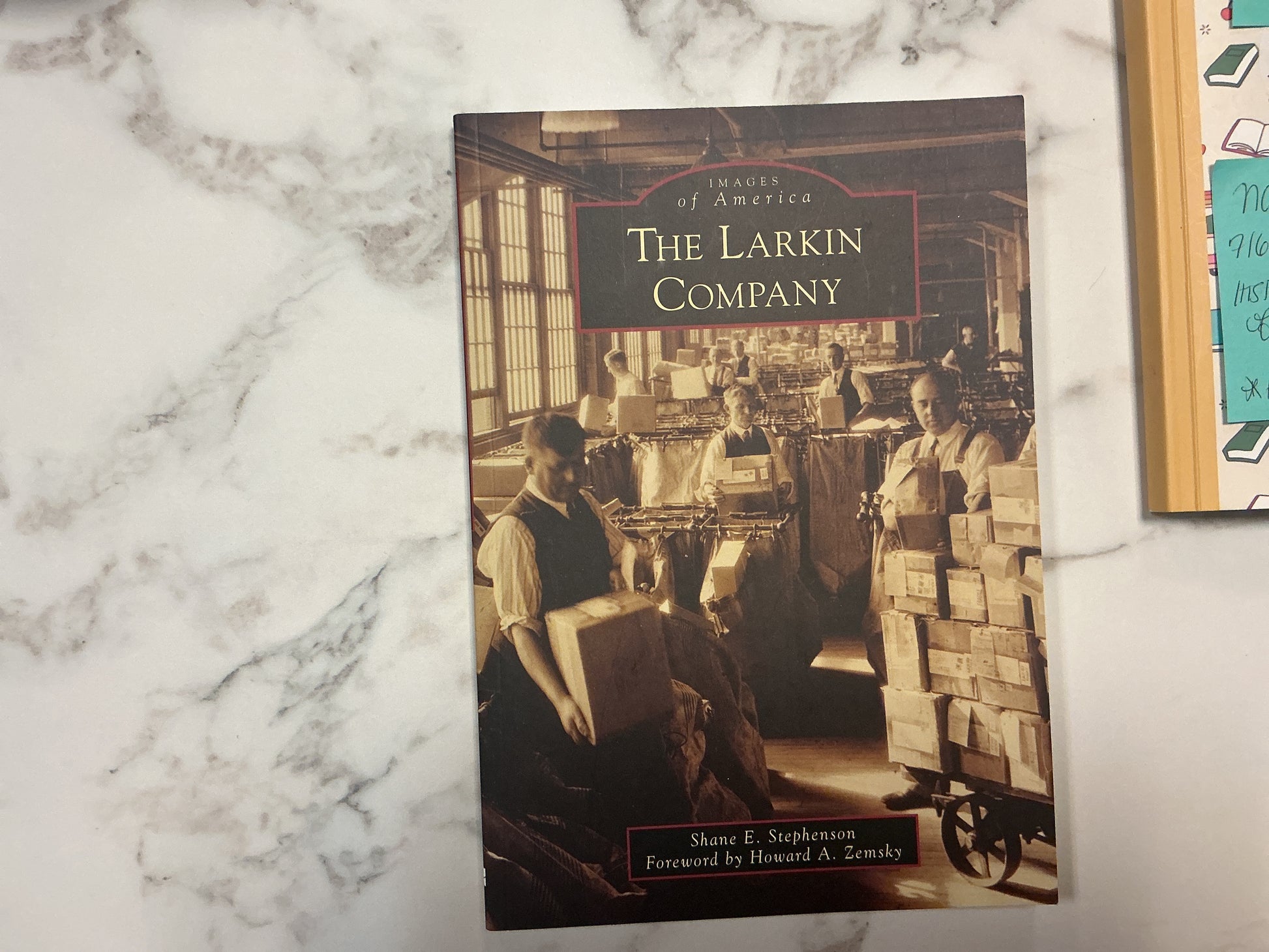 Book titled 'The Larkin Company' on a marble surface