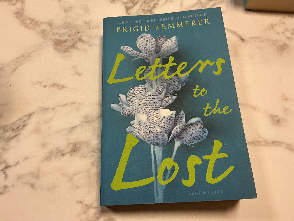 Book titled 'Letters to the Lost' by Brigid Kemmerer on a marble surface