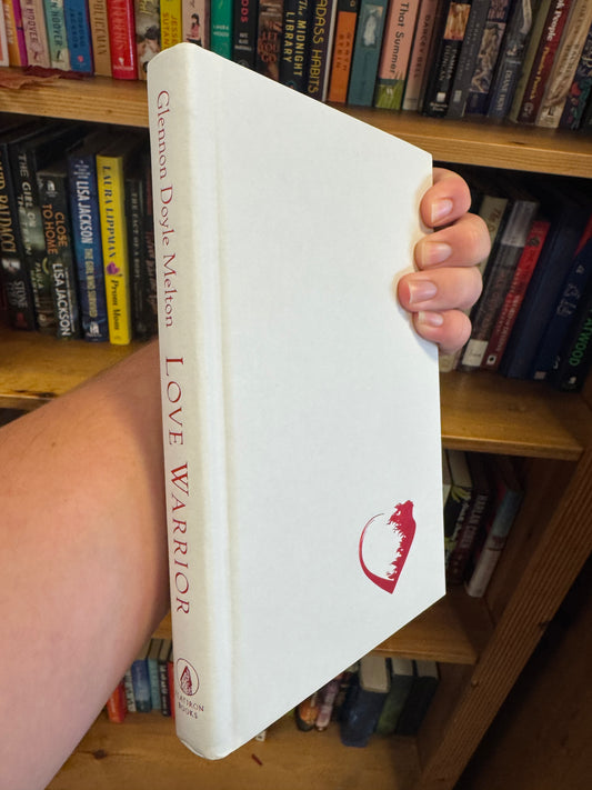 Love Warrior hardcover book by Glennon Doyle with red spine and heart logo