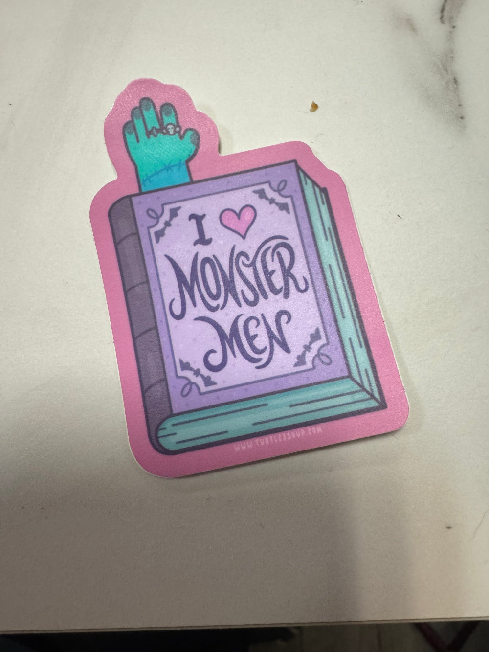 Sticker of a book with 'I heart monster men' text on a white background