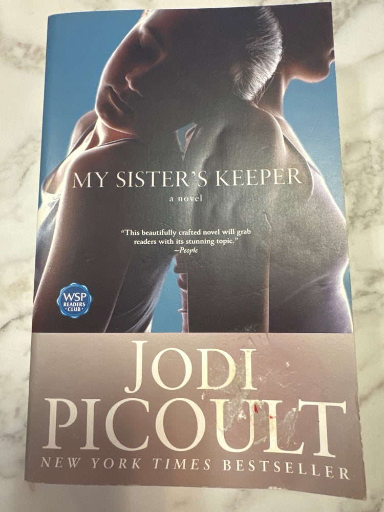 My Sister's Keeper paperback by Jodi Picoult with blue cover art and WSP Readers Club sticker
