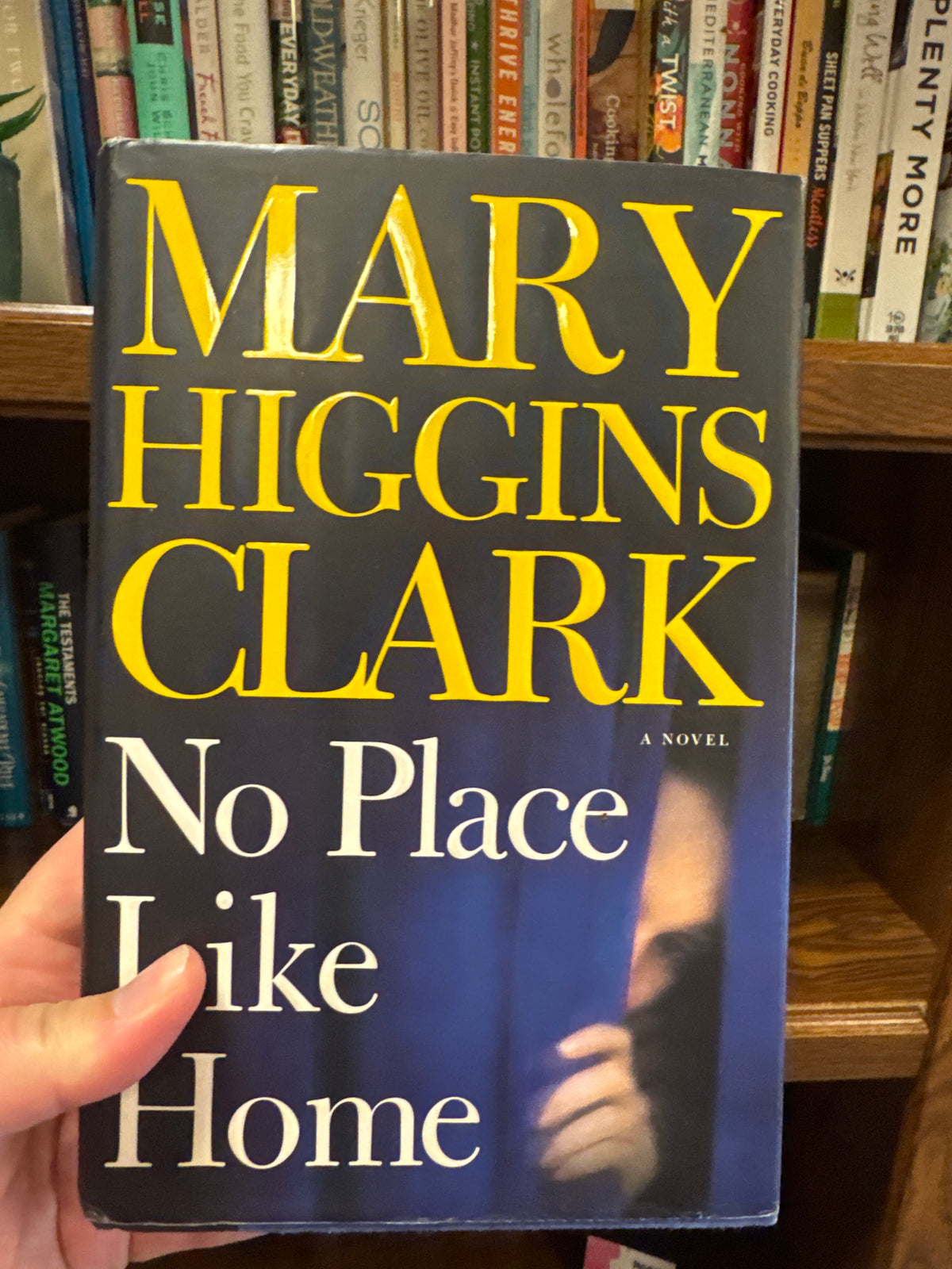 No Place Like Home hardcover novel by Mary Higgins Clark with dark blue cover and yellow author text