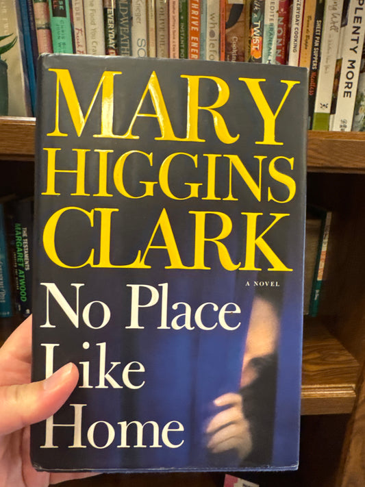 No Place Like Home hardcover novel by Mary Higgins Clark with dark blue cover and yellow author text