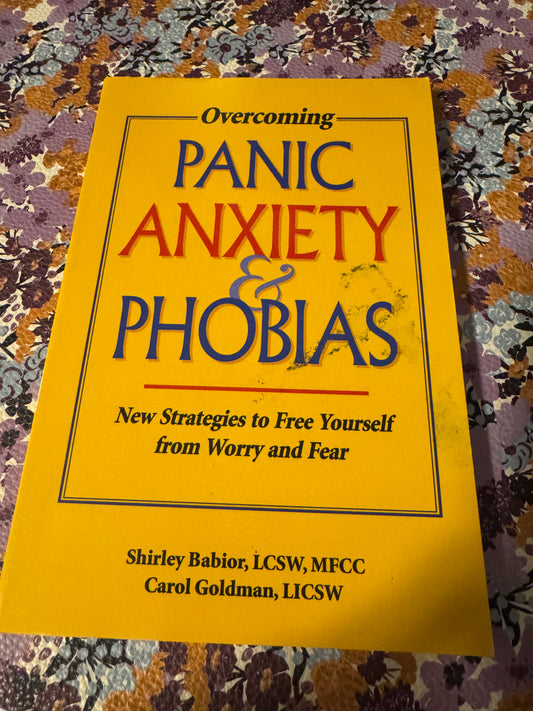 Overcoming Panic Anxiety & Phobias paperback book by Shirley Babior and Carol Goldman on floral fabric