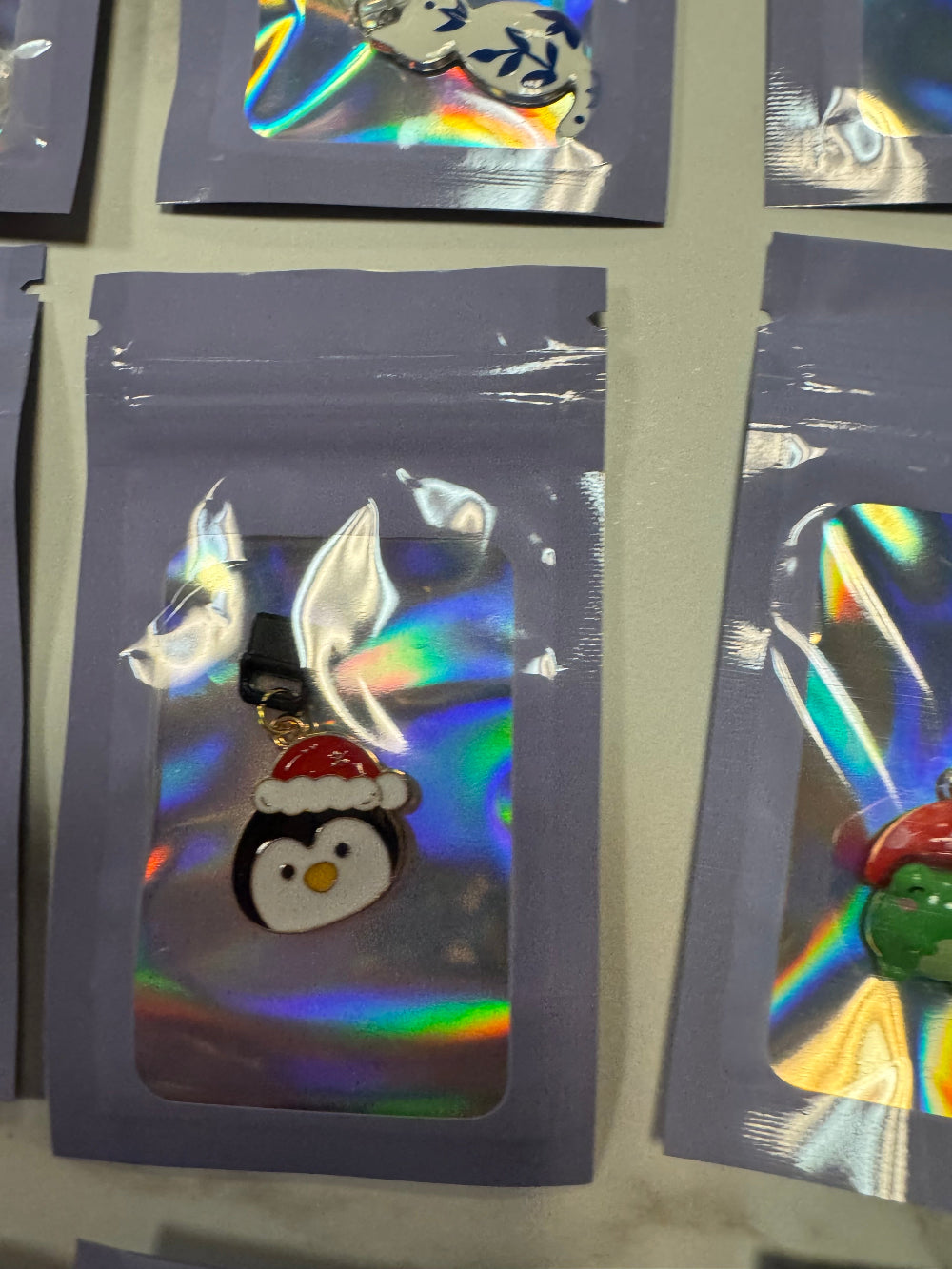 Holographic packaging with Penguin Kindle Charm