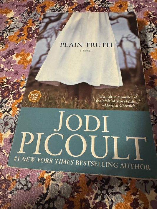 Plain Truth paperback by Jodi Picoult with WSP Readers Club sticker on floral fabric
