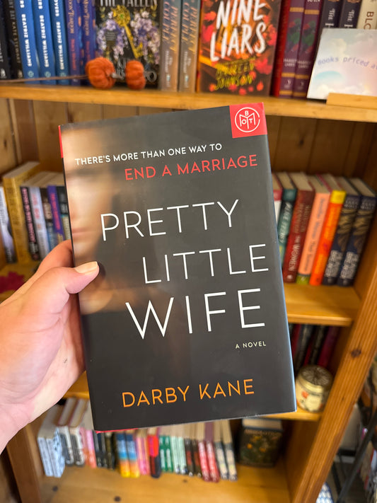 Pretty Little Wife paperback novel by Darby Kane with white and red cover text