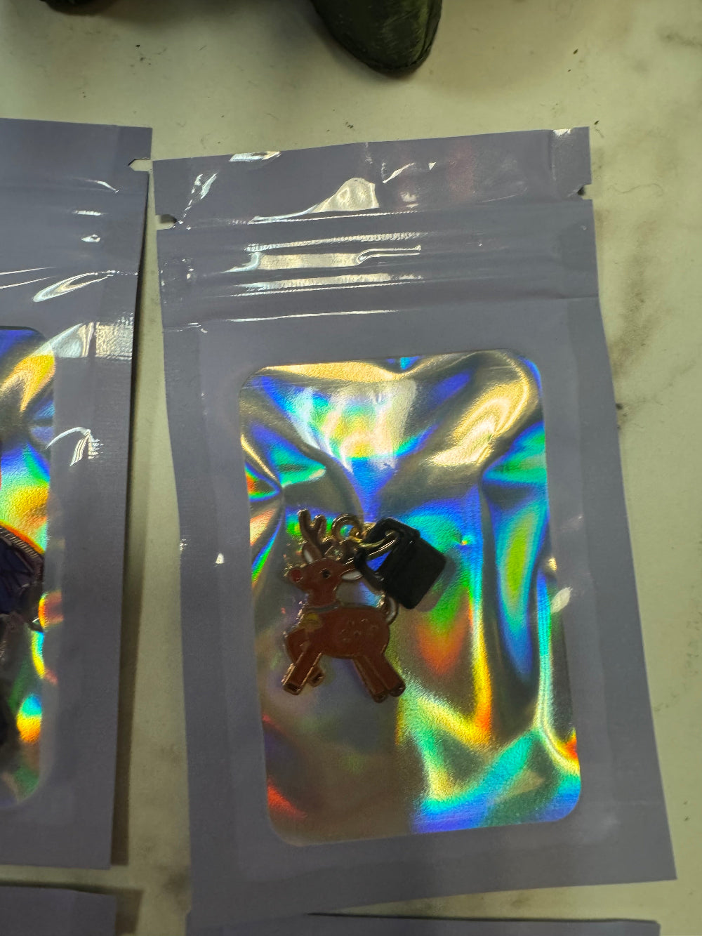 Holographic Packaging with Rudolph the Reindeer Kindle Charm in it